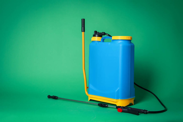 Manual insecticide sprayer on green background, space for text. Pest control - 写真・画像