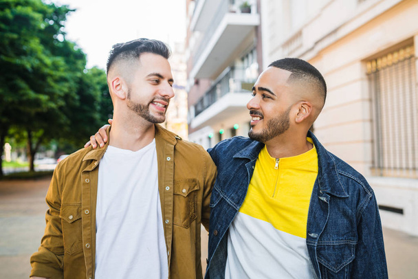 Portrait of happy gay couple spending time together while walking in the street. Lgbt and love concept. - Foto, afbeelding