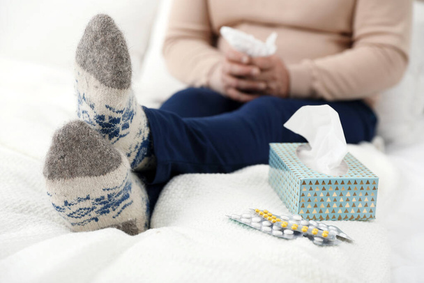 Mature man and cold remedies on bed, closeup. Dangerous virus - Photo, Image