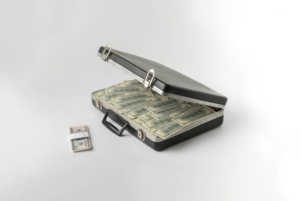 the opened vintage case full of cash dollar money, hundred banknote on color surface - Фото, изображение