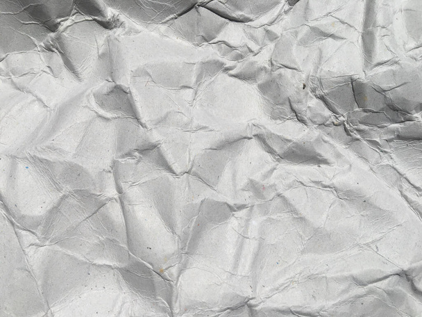 Πάνω όψη του λευκού τσαλακωμένου χαρτιού φόντο υφή. Αντιγραφή χώρου για σχεδιασμό και έργα τέχνης - Φωτογραφία, εικόνα