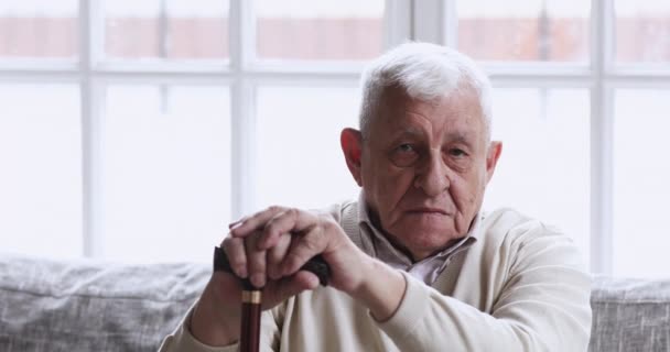 Happy older man hold walking stick looking at camera - Кадры, видео