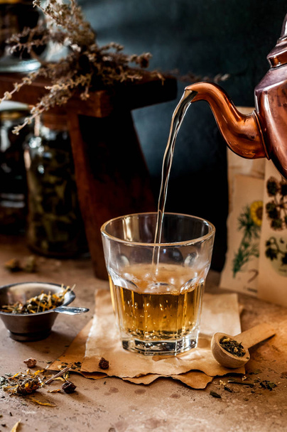Pouring Herbal Tea into a Glass, Variety of Dried Herb Mixes, copy space for your text - 写真・画像