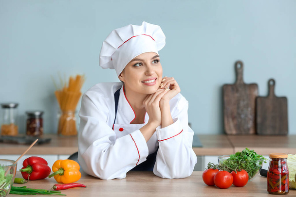 Beautiful female chef in kitchen - Fotografie, Obrázek