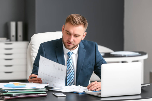 Male accountant working in office - Foto, afbeelding