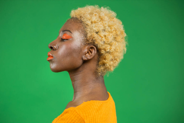African american woman in profile isolated on green background. Black Women Protection Rights Concept, Strong Women, Independent Women - Foto, Imagen