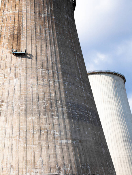 Cooling tower of the cogeneration plant in Kyiv (Ukraine). Working platform (crane's cradle, basket, workshop crane, high rise suspended platform, gondola building platform) on the wall. Maintenance of the tower. - Photo, Image