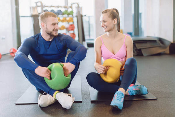 Man and woman doing stomach or abdominal exercises together - Foto, Bild