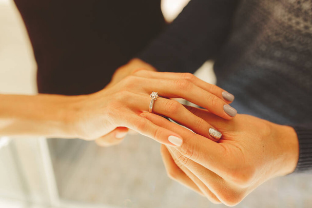 picture of man and woman with wedding ring, newlyweds choose and buy a wedding ring in a jewelry store. - Фото, зображення