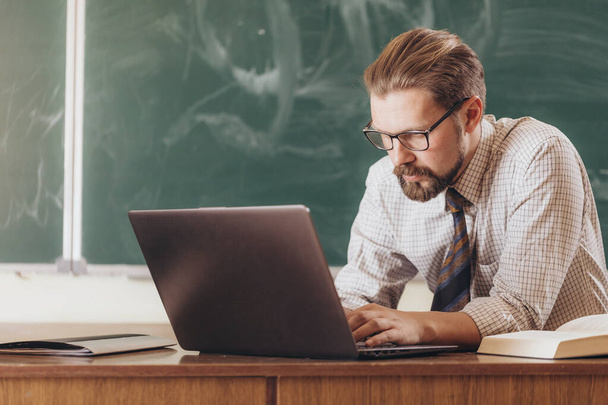 Teacher in Glasses Using Laptop During Break - Φωτογραφία, εικόνα
