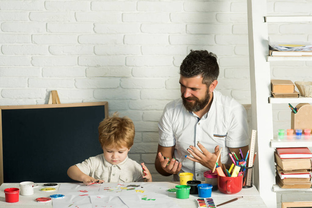 Finger painting. Happy father with his son. Weekend. Drawing for the development of fine motor skills. Hobbies for preschooler. How to entertain a child. - Photo, Image