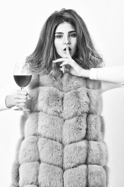 Woman enjoy wine. Hedonism concept. Lady curly hairstyle likes expensive luxury wine. Reasons drink red wine in wintertime. Girl fashion makeup wear fur coat hold wine glass. Alcohol and cold weather - Foto, Imagen