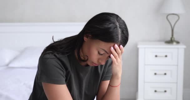 Depressed african american woman feel anxiety sit alone on bed - Felvétel, videó
