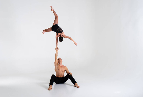 Duo Of Acrobats Showing hand to hand Trick, Isolated On White - Valokuva, kuva