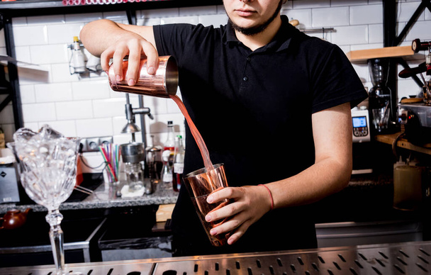 Bartender is making cocktail at bar counter. Fresh cocktails.  - Фото, изображение
