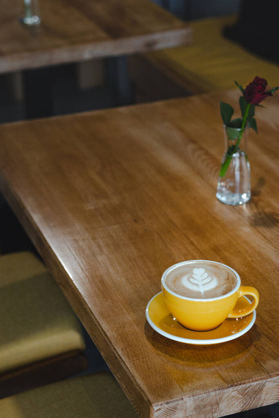 A Yellow Cup of Coffee in the Coffee Shop - Фото, зображення