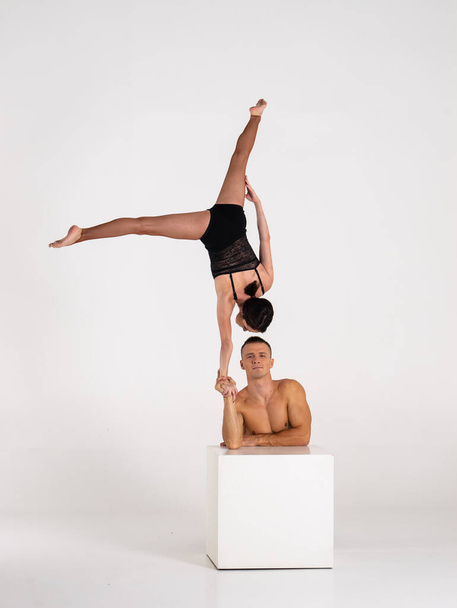 Duo Of Acrobats Showing hand to hand Trick, Isolated On White - 写真・画像
