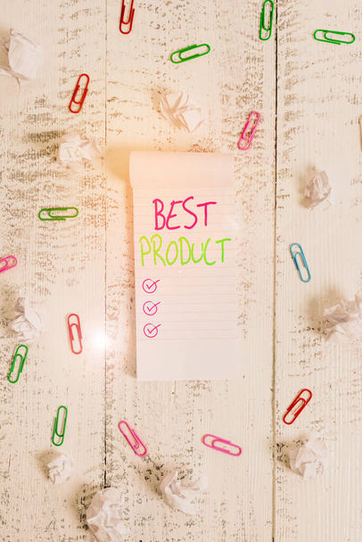 Conceptual hand writing showing Best Product. Business photo showcasing very popular and a large quantity of it has been sold Stripped ruled notepad clips paper balls wooden background. - Fotoğraf, Görsel