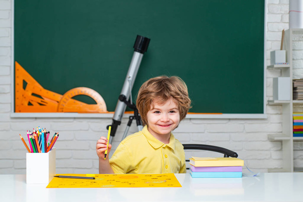 Beginning of lessons. Home school for pupil. Home schooling. Child near chalkboard in school classroom. - Φωτογραφία, εικόνα