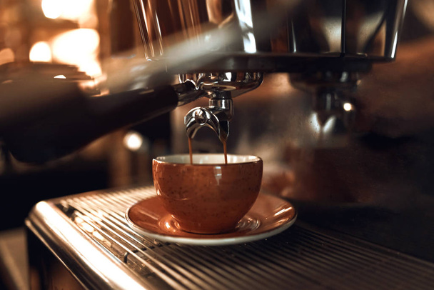 process of pouring coffee stream from professional machine in cup. - Foto, afbeelding