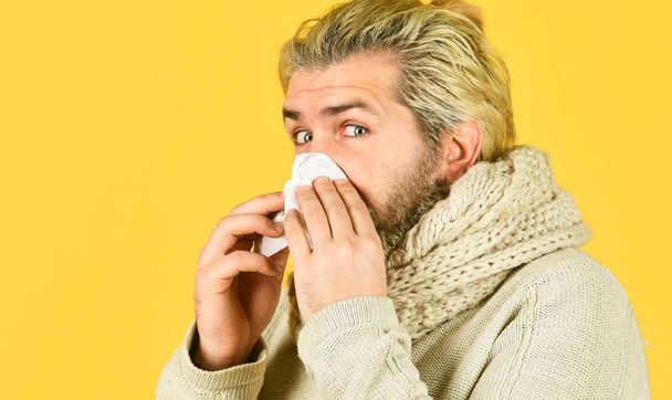 infection carrier. brutal man beard has runny nose. flu virus infection symptoms. coronavirus from china. immunity against epidemic. hipster blow out nose in paper. Allergy concept. Home treatment - Φωτογραφία, εικόνα