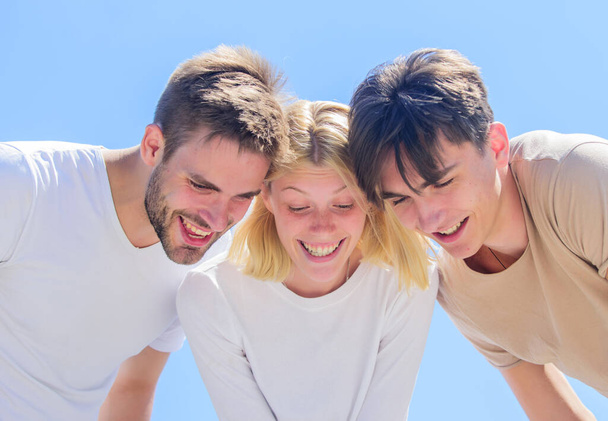 Look here. Carefree youth hang out together. See something adorable. Happiness. Group people excited look down. Woman and men happy sky background. Happiness in unity. Open mind for happiness - Фото, изображение