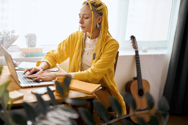 composer working at home.stylish girl with yellow dreads creating a music - Zdjęcie, obraz