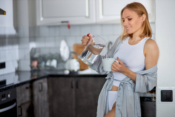 happy woman enjoy drinking fresh water in morning - Valokuva, kuva