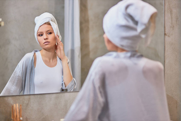 attractive lady look at mirror in bathroom - Fotoğraf, Görsel