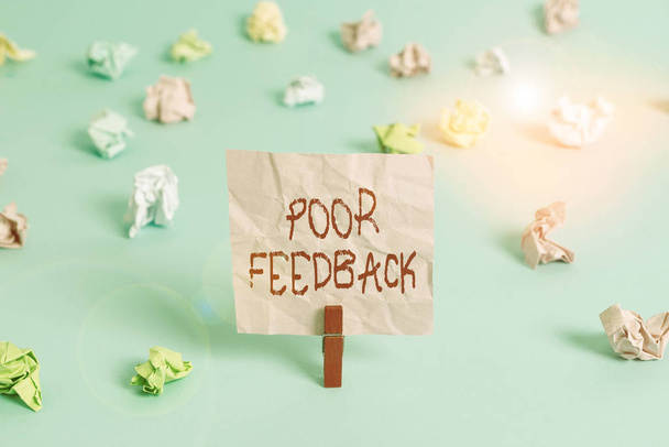 Writing note showing Poor Feedback. Business photo showcasing A response or reaction that causes a decrease in function Colored crumpled rectangle shaped reminder paper light blue background. - Fotografie, Obrázek