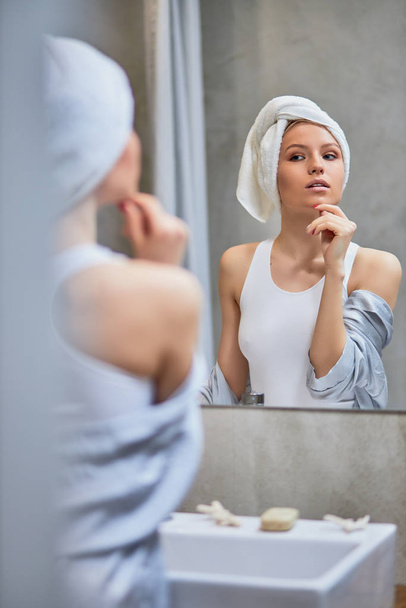 good-looking caucasian woman with towel on head in bathroom - Фото, зображення