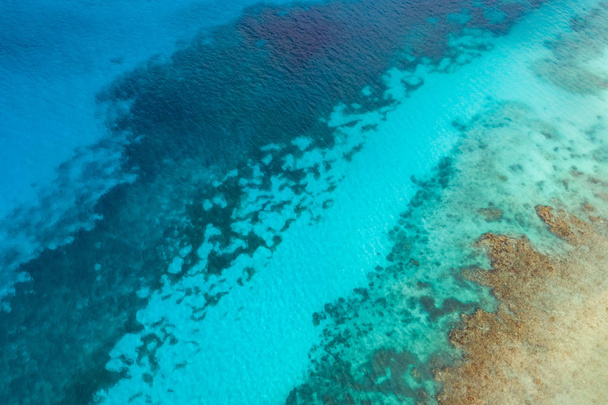 Aerial view of blue ocean with underwater coral reef, tropics.   - Фото, изображение