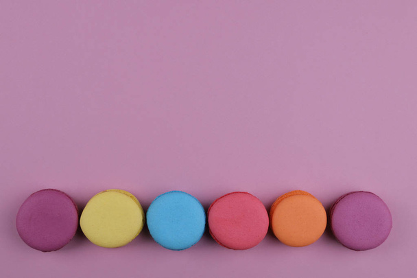 colored french macaroons on a pink background - Fotografie, Obrázek