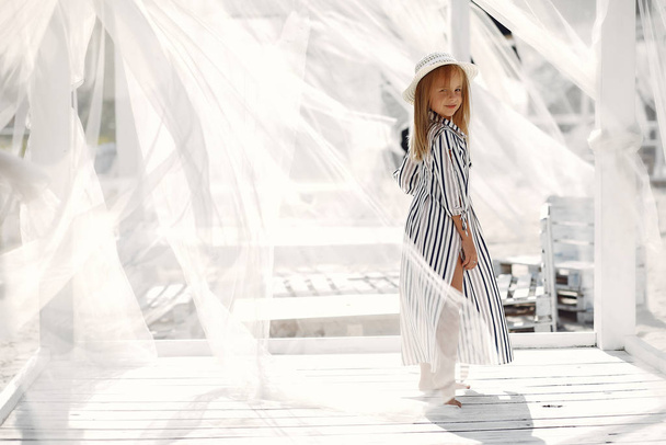 Elegant little girl on a summer coast - Valokuva, kuva