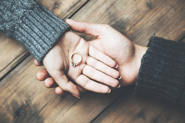 young couple hand ring on wooden table - 写真・画像