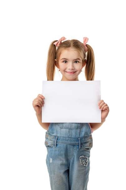 Happy cute child girl holding empty blank - Valokuva, kuva