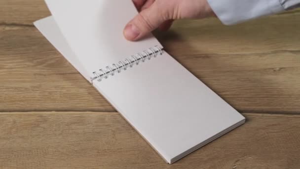 Hand turns over the notepad sheets for your text. Close up. - Footage, Video