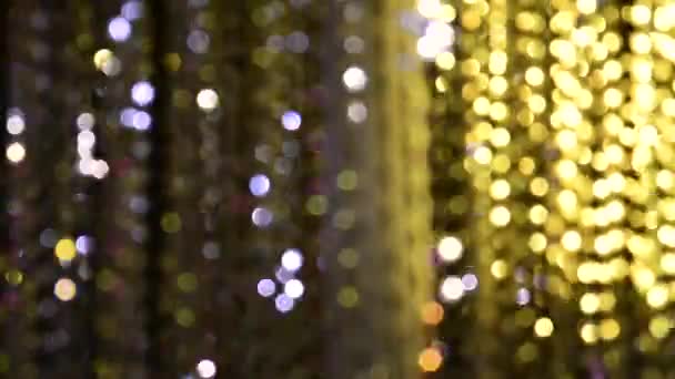 Lekkie oświetlenie z girlandy migających świateł w postaci bokeh bieli, fioletu i złota. Koncepcja wakacje, Boże Narodzenie, oświetlenie, impreza. - Materiał filmowy, wideo