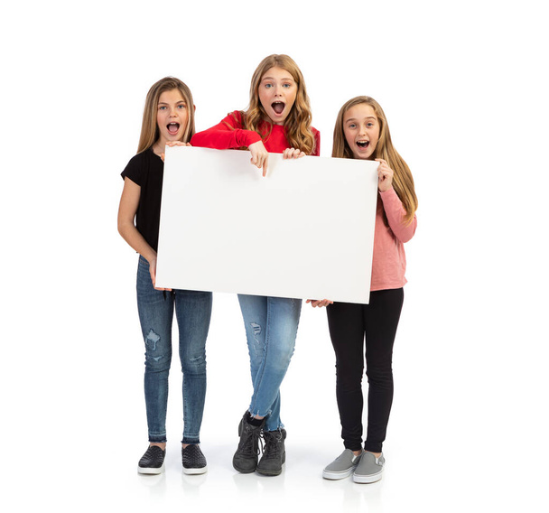 Group of kids in various poses with props, isolated on a white background. - Foto, afbeelding