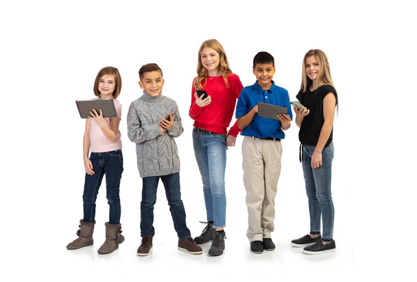 Group of kids in various poses with props, isolated on a white background. - Foto, Imagen