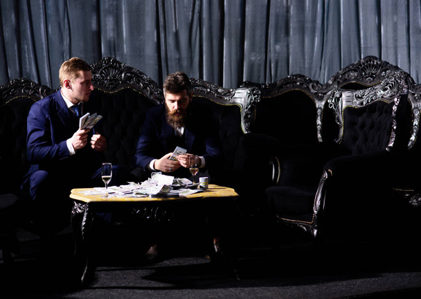 Illegal deal concept. Men in suit, businessmen sit - Фото, зображення