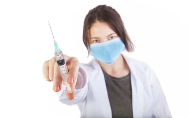 nurse woman holding syringe for virus protection. focus on the hand - Photo, Image