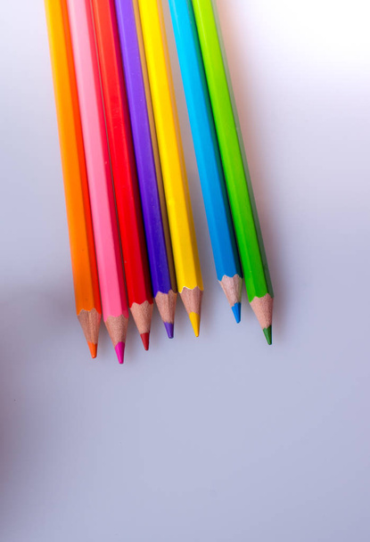 Hand holding color Pencils placed on a white background - Photo, Image