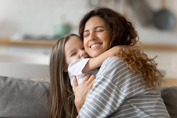 Overjoyed mother and daughter relax having fun on couch - Photo, Image