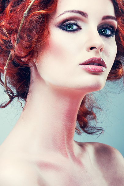 Red hairs. Portrait of beautiful girl in a chaplet from branches. - Photo, image
