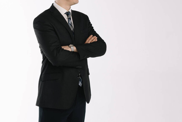 portrait of a businessman standing on a white background with folded hands - Фото, зображення