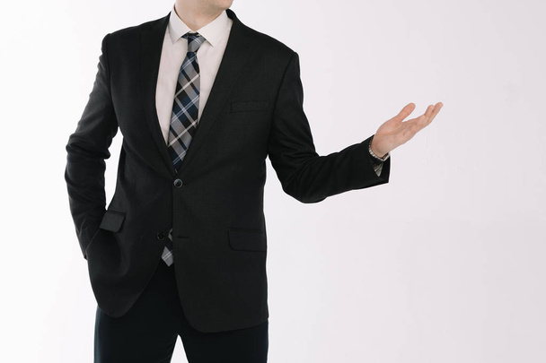 portrait of a businessman standing on a white background with his hand outstretched - Photo, image