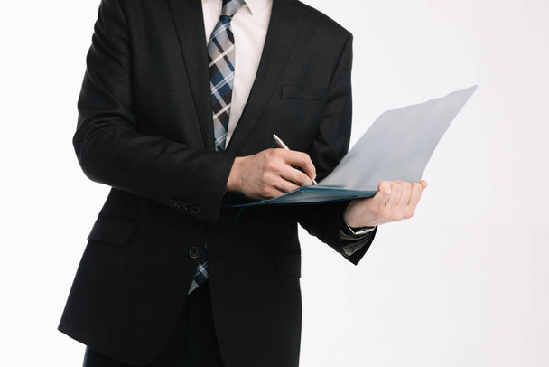 business document. business man, writing on a tablet on a blank sheet. A businessman in a businessman's suit signs a document on a white background. - Foto, imagen
