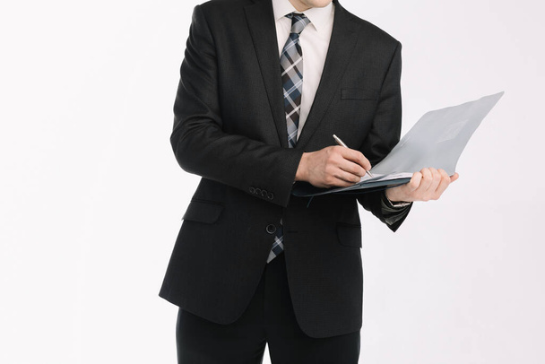 business document. business man, writing on a tablet on a blank sheet. A businessman in a businessman's suit signs a document on a white background. - Foto, immagini