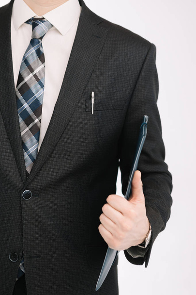 business document. business man, writing on a tablet on a blank sheet. A businessman in a businessman's suit signs a document on a white background. - Photo, Image